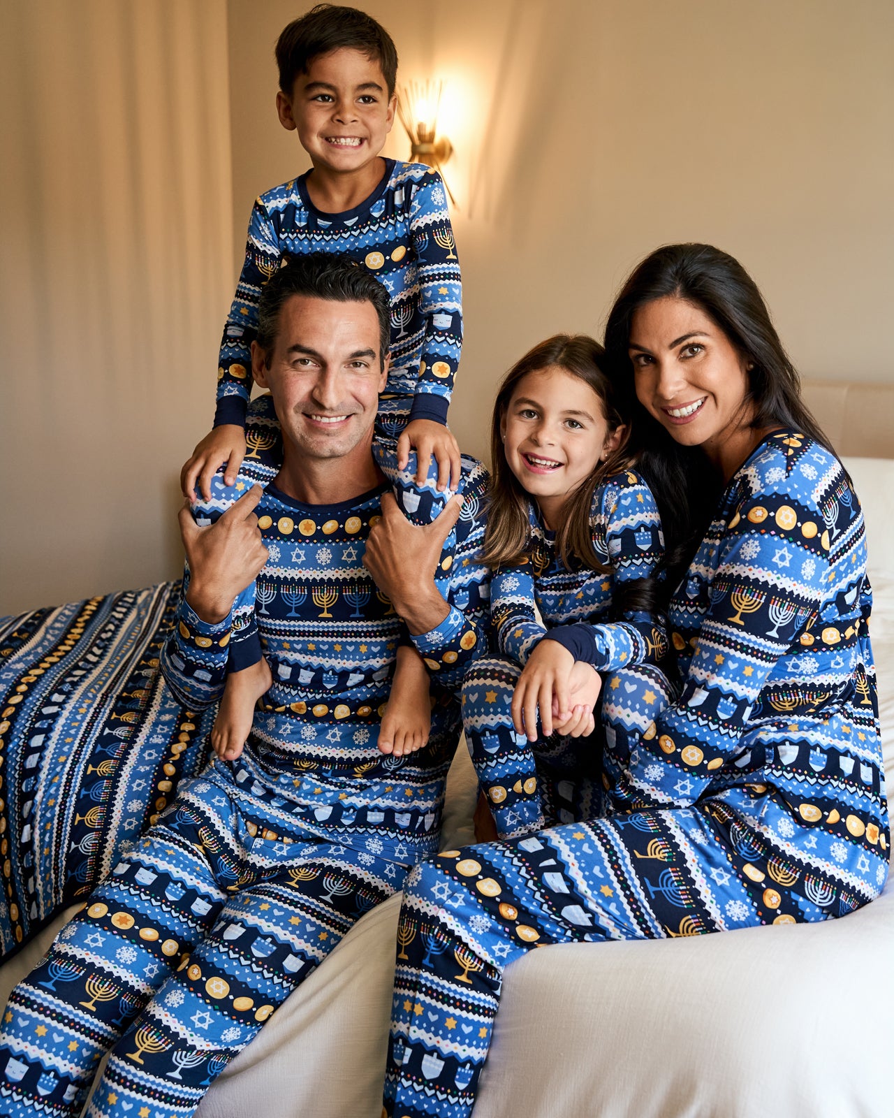 Family of four wearing coordinating Hanukkah Fair Isle bamboo pajamas