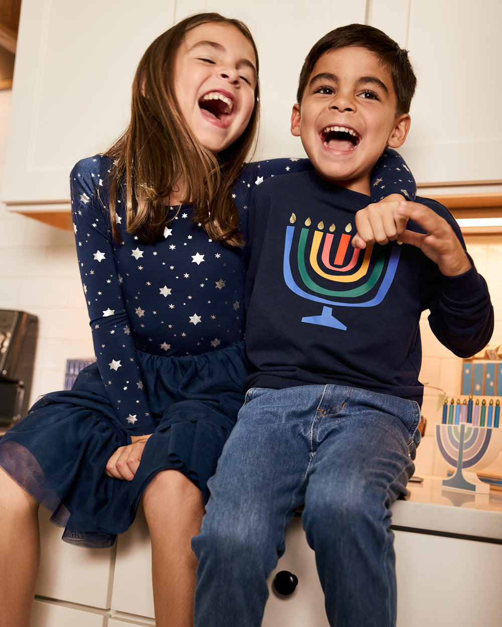 Two children wearing styles from the Hanukkah collection