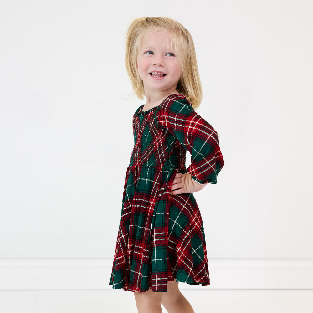 Image of a girl wearing a Fireside Plaid Smocked Dress with Bloomer