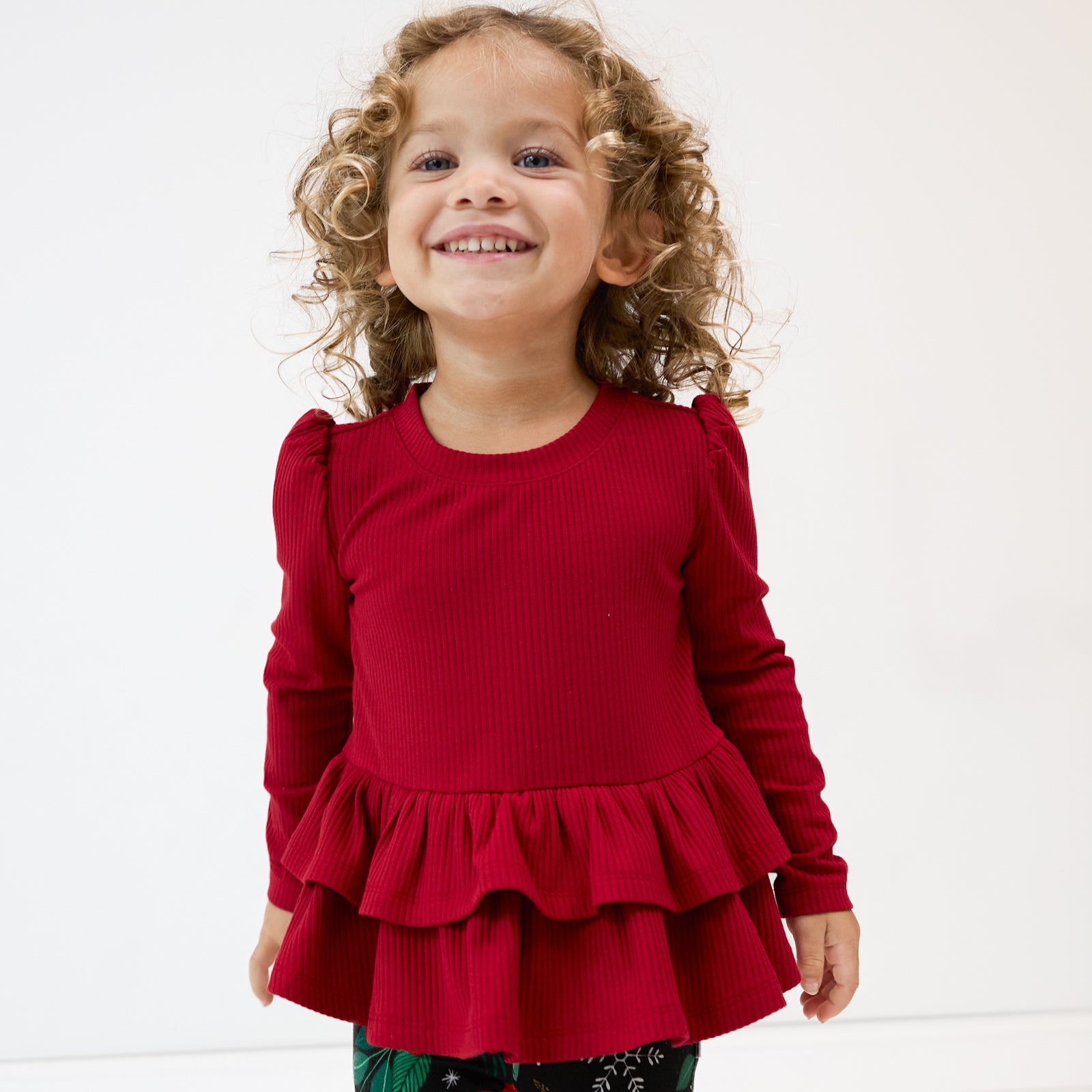 Alternate close up image of a child wearing a Holiday Red Ribbed Tiered Peplum Top