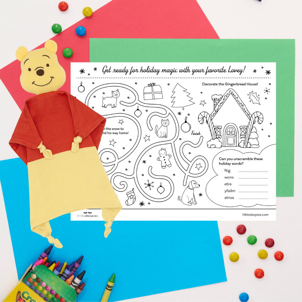 Flat lay image of a Winnie the Pooh lovey with a Holiday coloring sheet