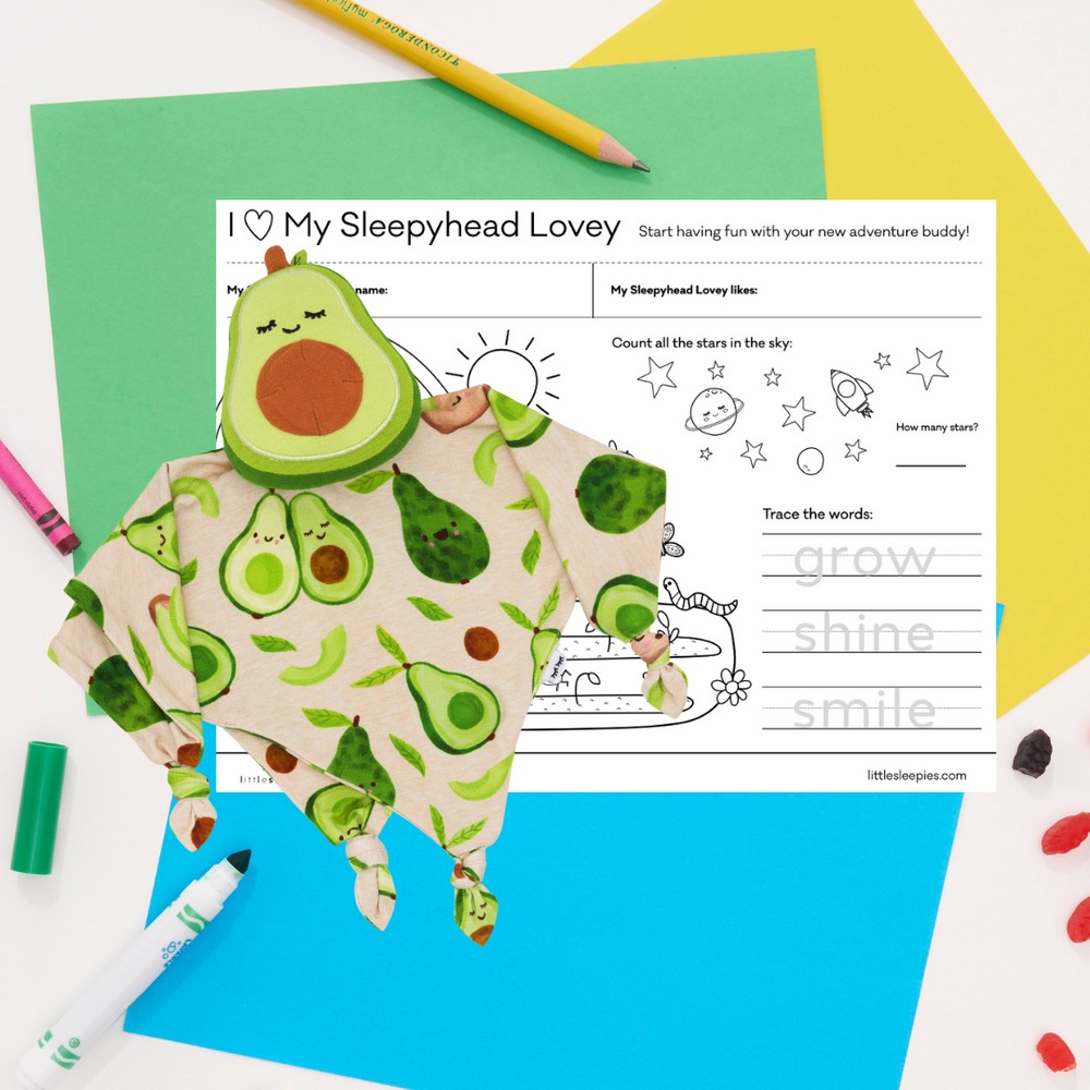 Flat lay image of a Guac the Avocado sleepy head lovey and a free printable coloring sheet