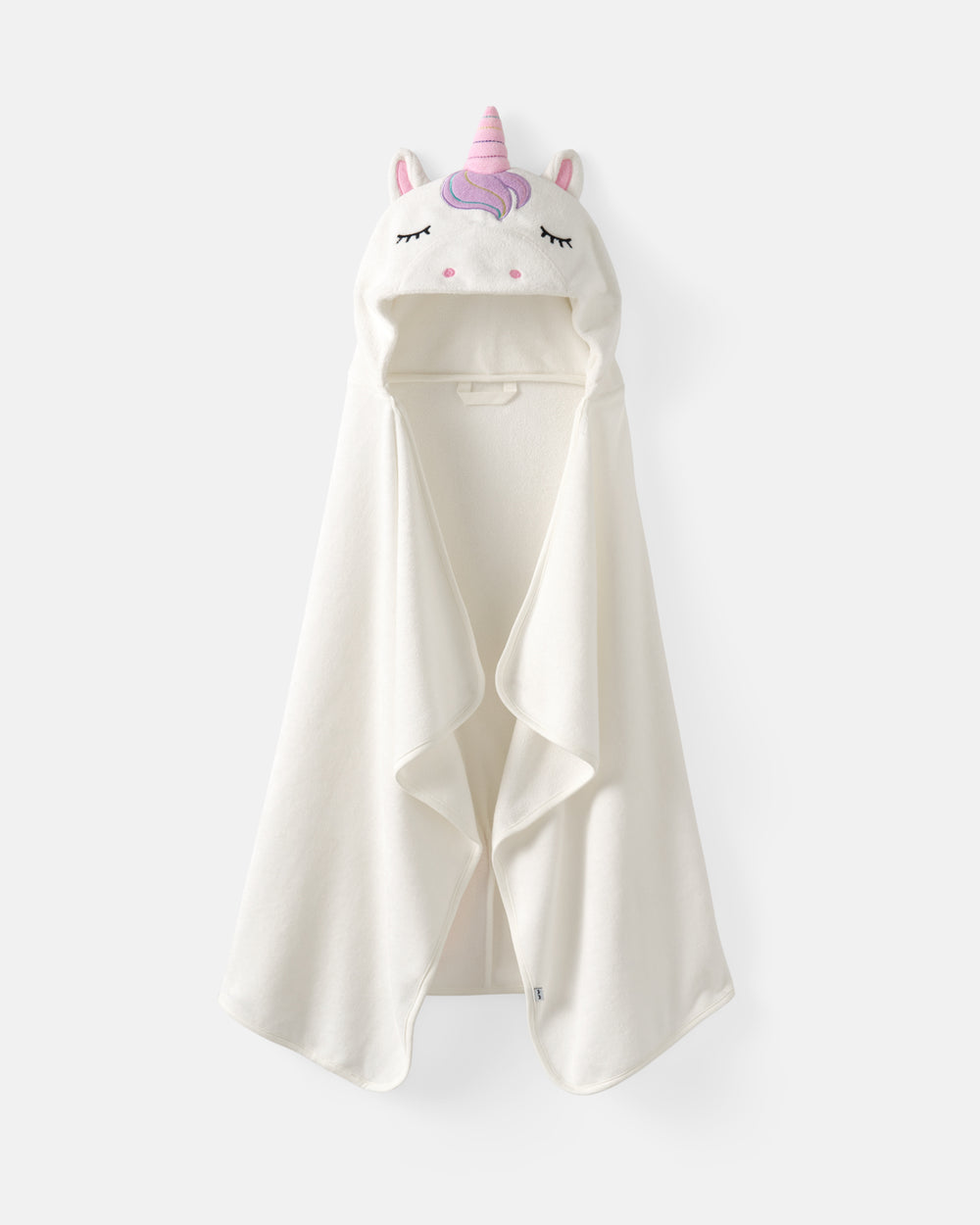 An off-white hooded towel or blanket featuring a plush unicorn face with a pink horn and ears, shown against a light gray background.