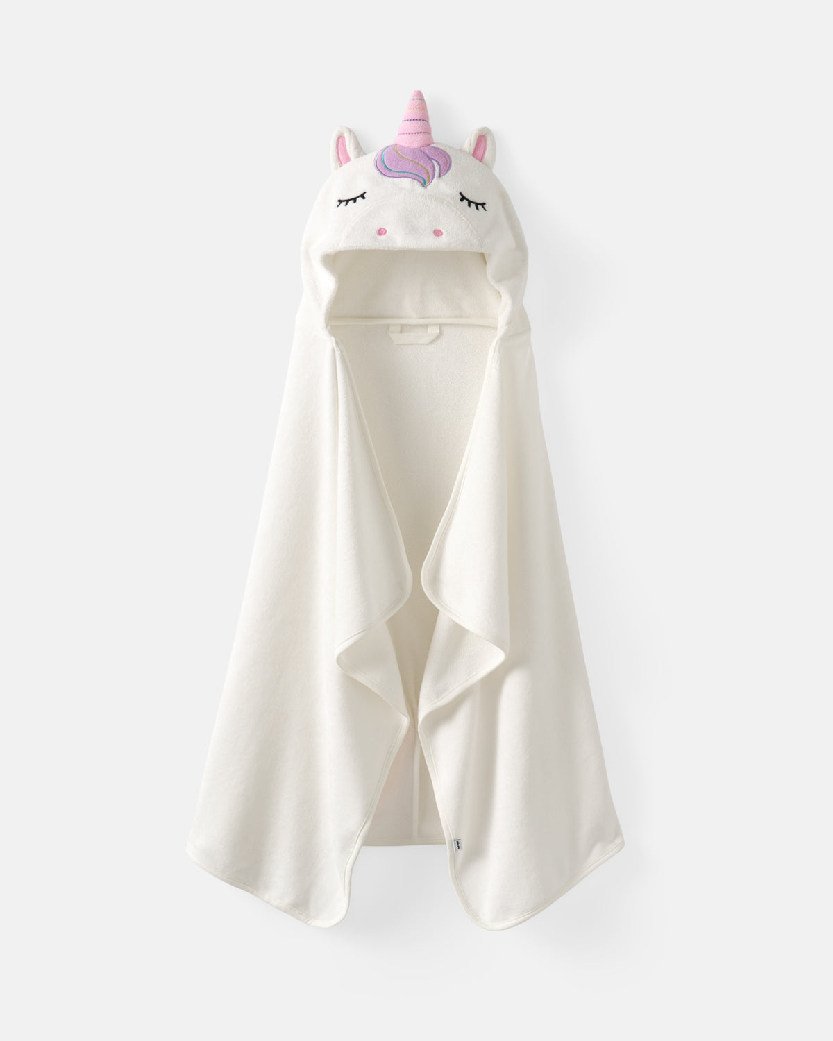 An off-white hooded towel or blanket featuring a plush unicorn face with a pink horn and ears, shown against a light gray background.