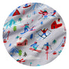 A circular close-up of a light gray fabric with a colorful winter ski resort print, featuring skiers, snowboarders, pine trees, cabins, mountains, and ski lifts.