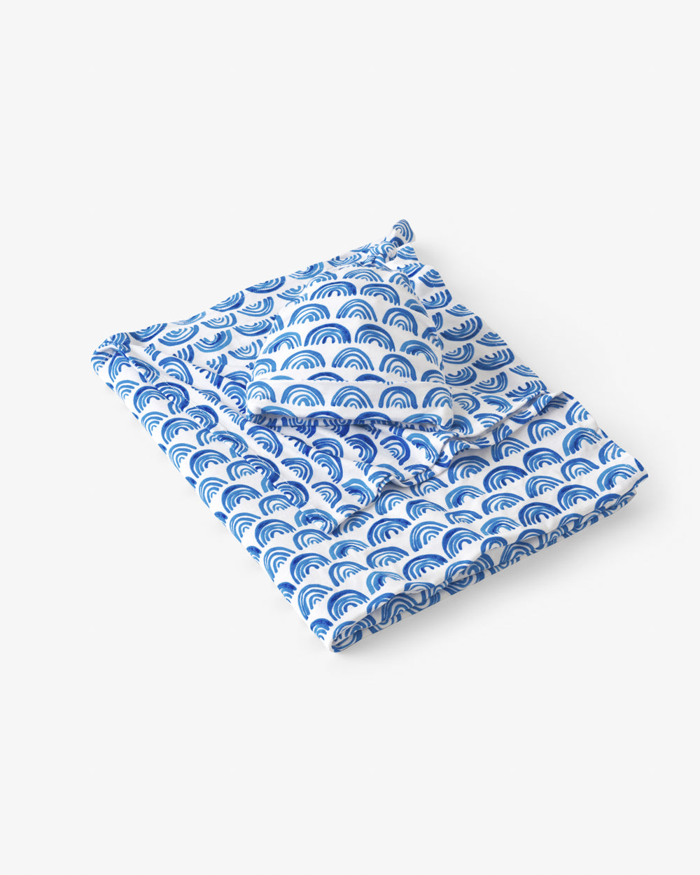 Flat lay of the Blue Rainbows Swaddle & Hat Set