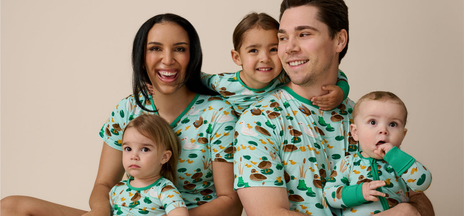 Family of five wearing matching pajamas with a duck pattern 