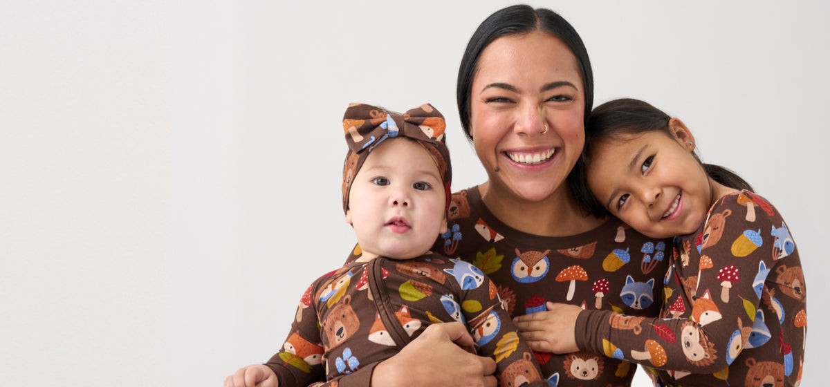 Mom and me matching in Little Sleepies new Fall bamboo pajamas with two small children.