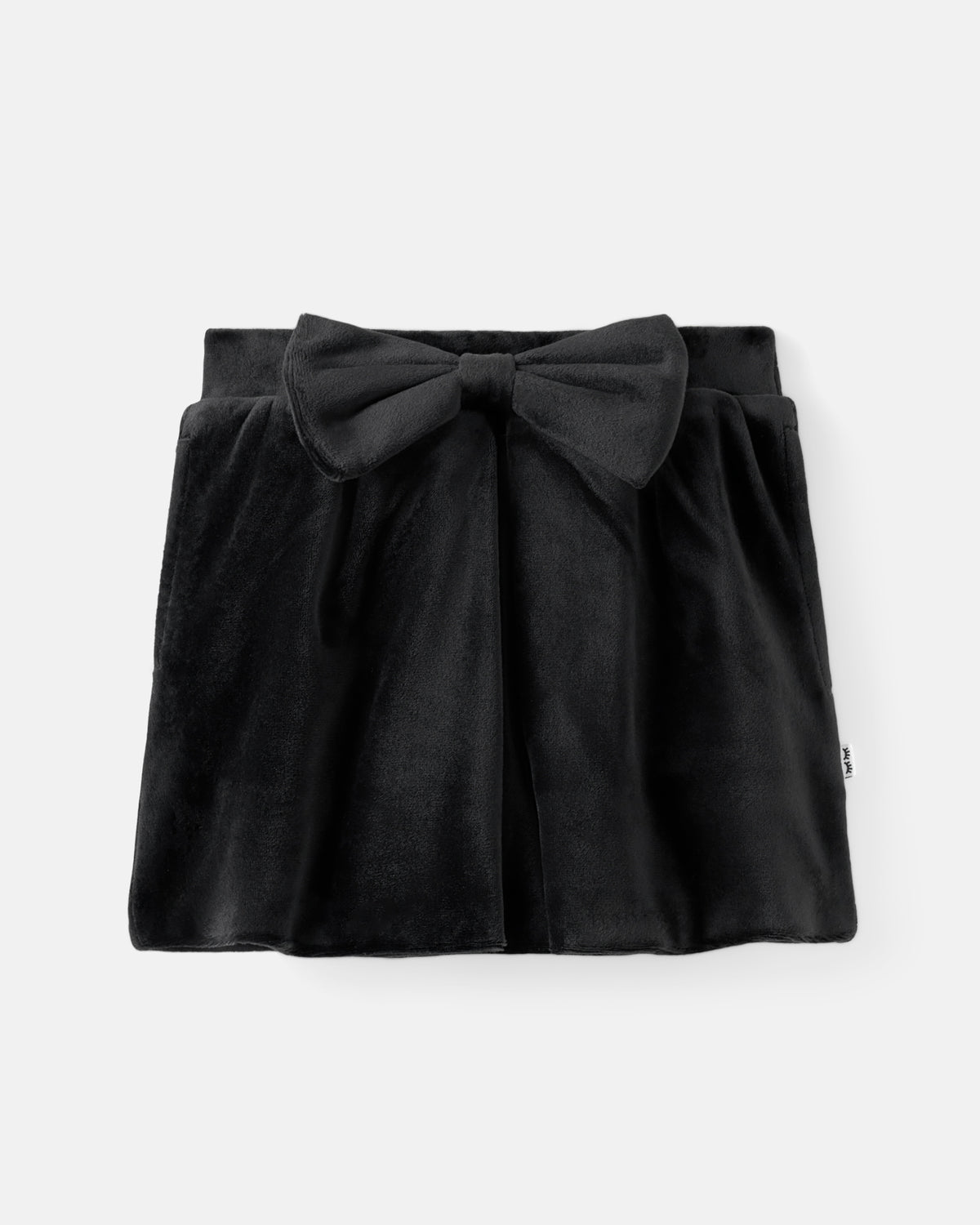A black velvet mini skirt with a large bow at the front waist, displayed flat against a light gray background.