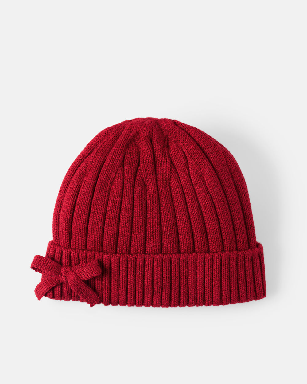 A red ribbed knit beanie hat with a matching fabric bow on the left side of the cuff, shown against a light gray background.