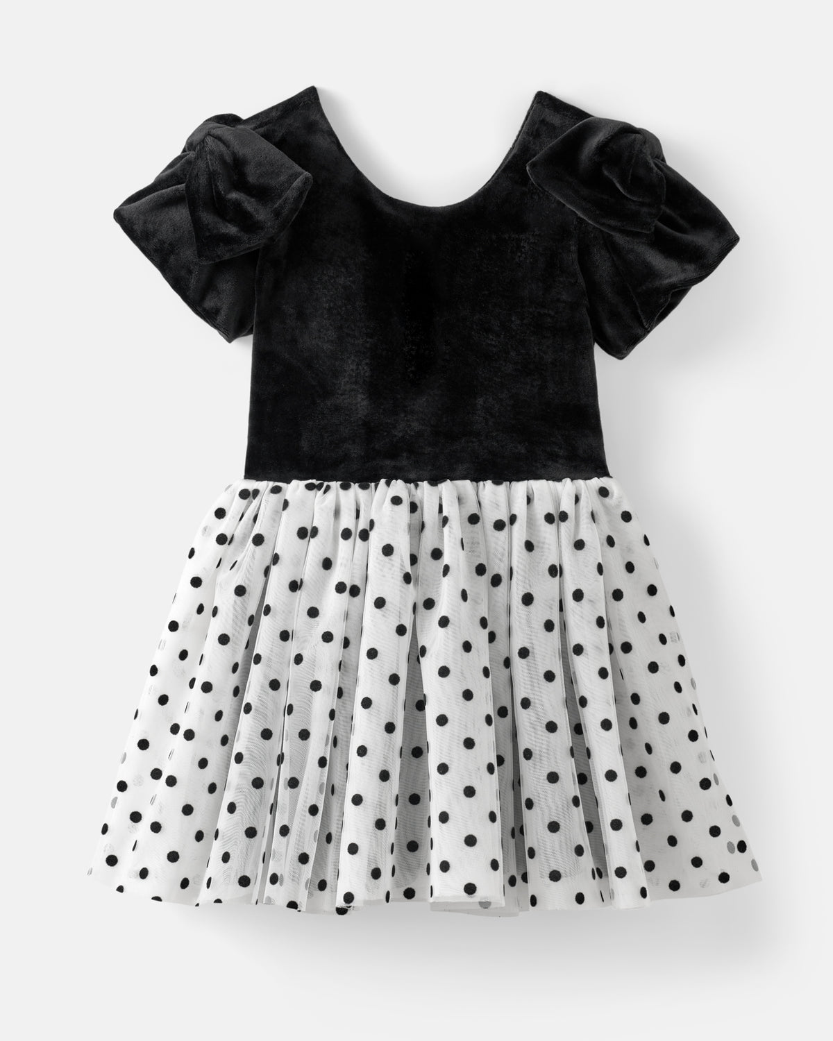 A toddler girl's dress featuring a black velvet bodice with ruffled short sleeves and a white pleated skirt with black polka dots, shown against a light gray background.