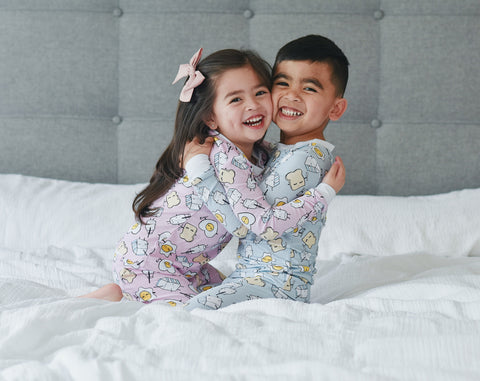 children hugging in sibling matching pajamas