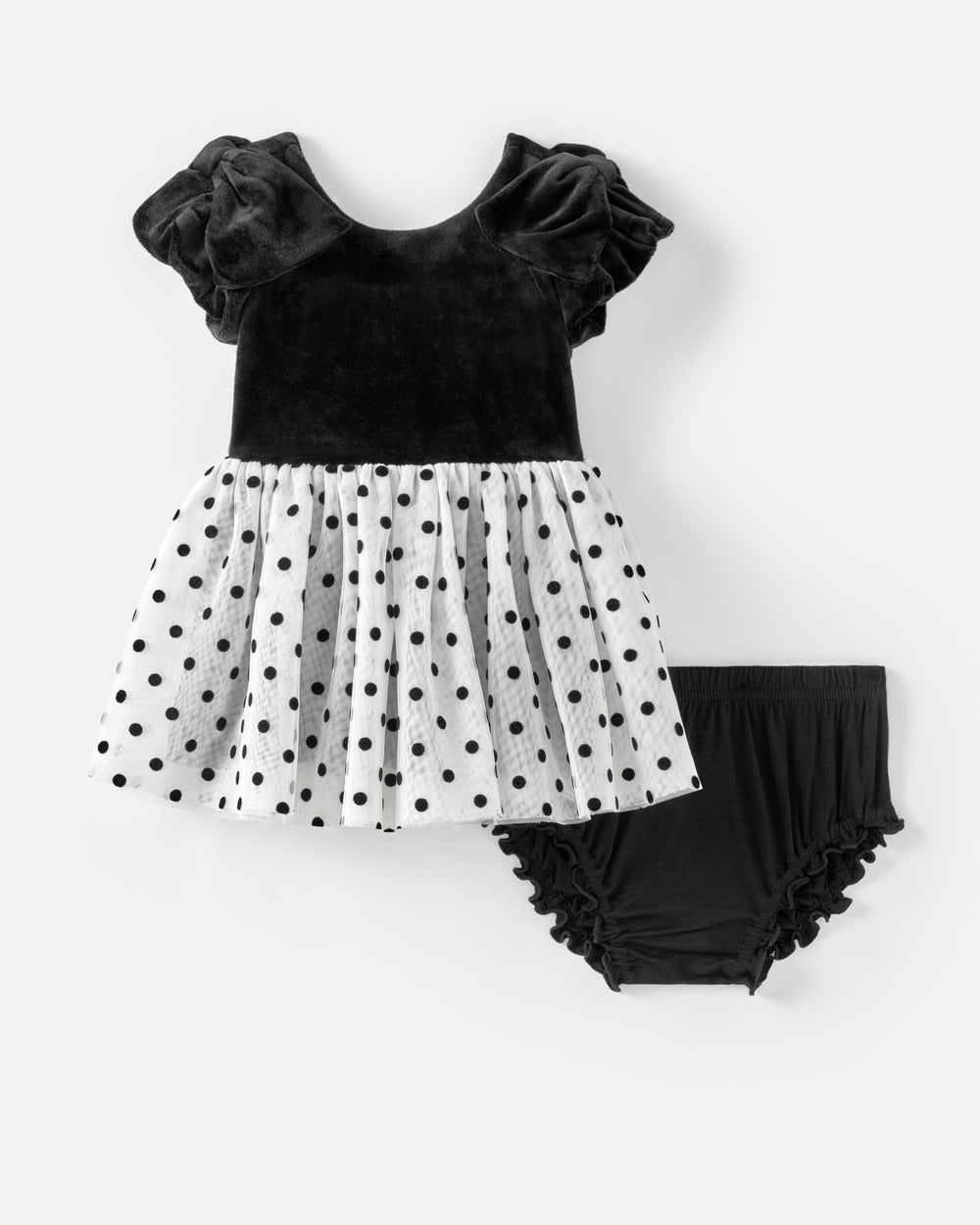 A toddler girl's two-piece outfit set featuring a black velvet top with ruffled flutter sleeves and a white polka-dot tulle skirt, paired with black ruffled bloomers, shown on a light gray background.
