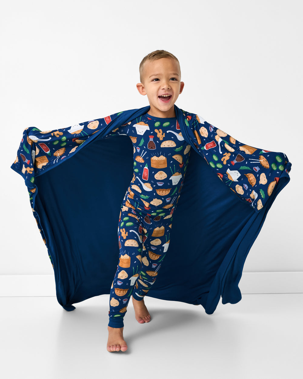 Running boy wrapped in the Bao Buddies Large Cloud Blanket®