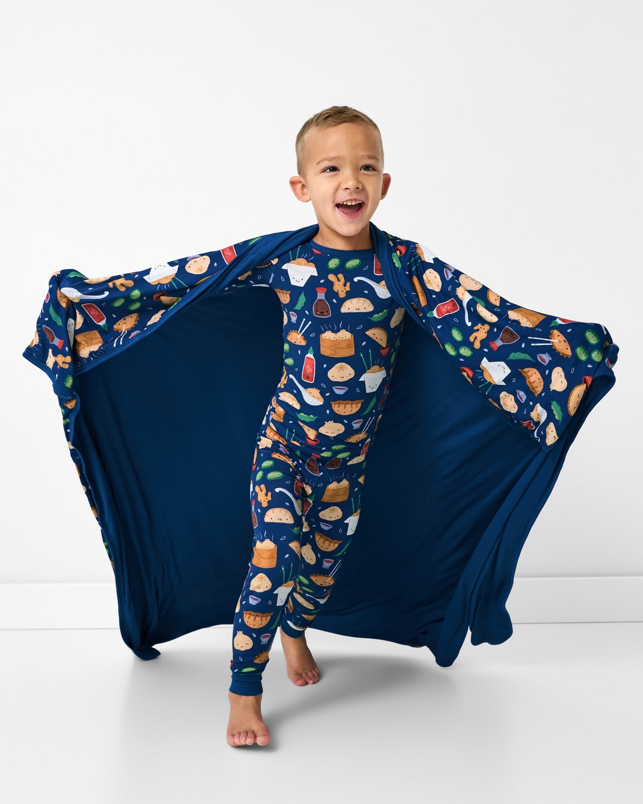 Running boy wrapped in the Bao Buddies Large Cloud Blanket®