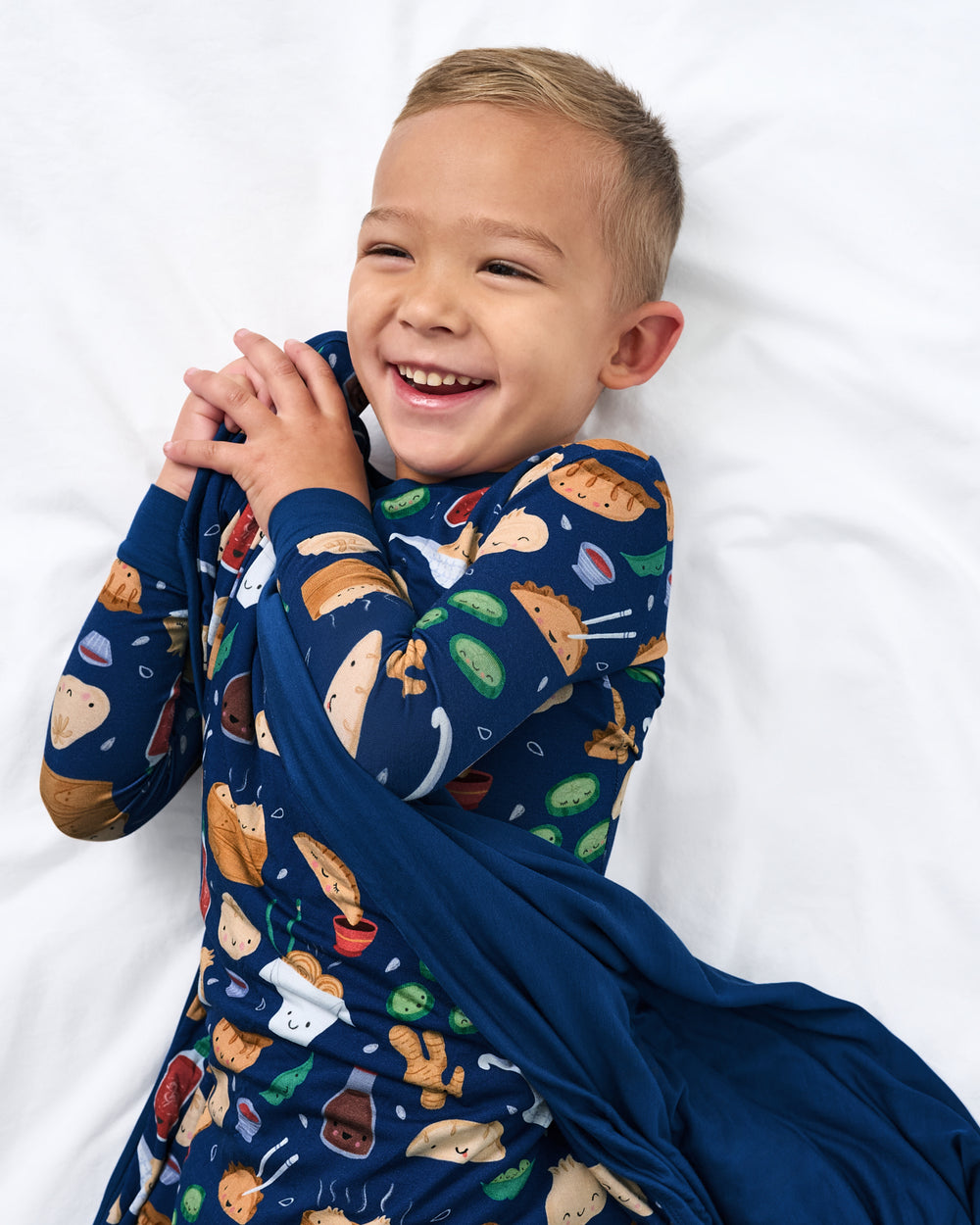 Aerial view of child cuddled with the Bao Buddies Large Cloud Blanket®