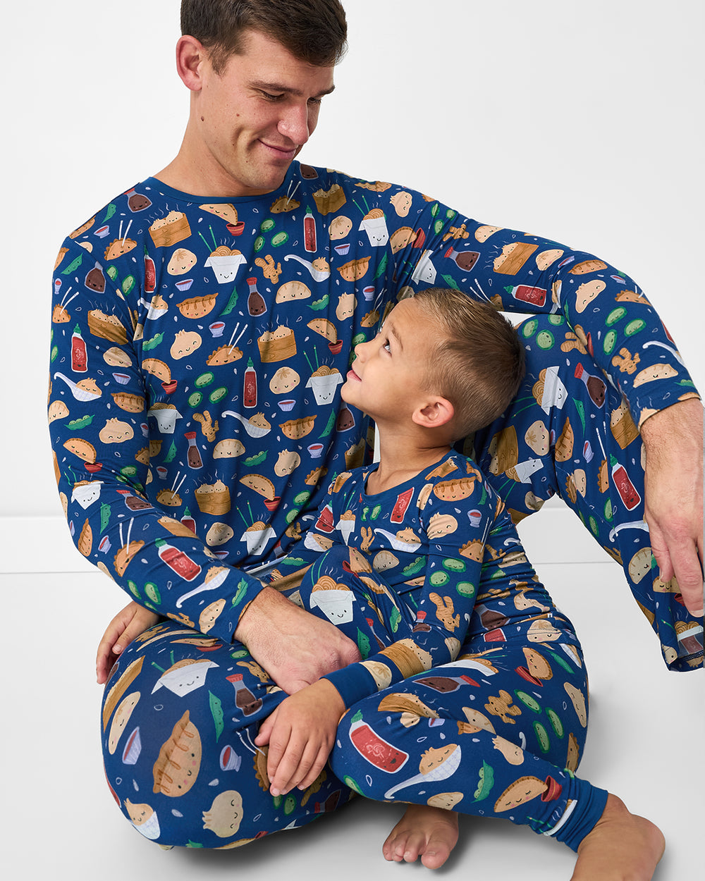 Father and son wearing matching Bao Buddies pajamas