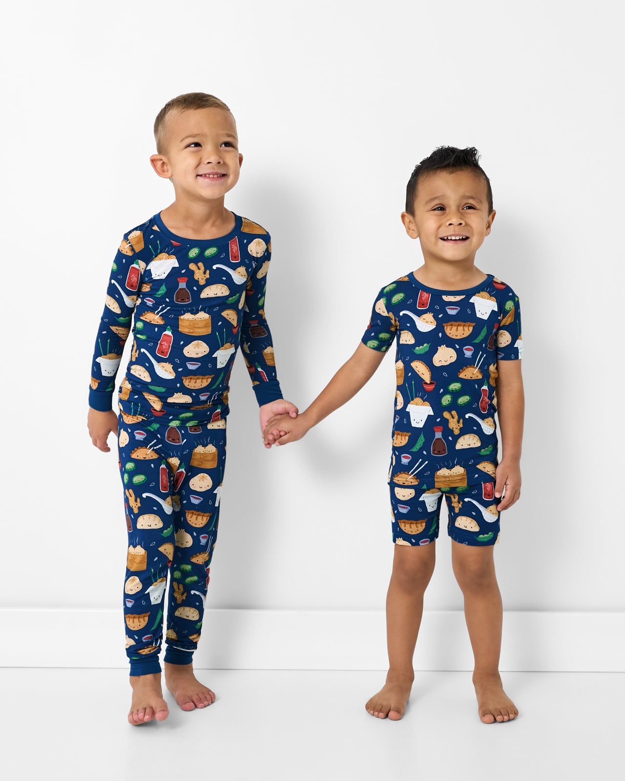 Two children wearing Bao Buddies Two-Piece Pajama Sets