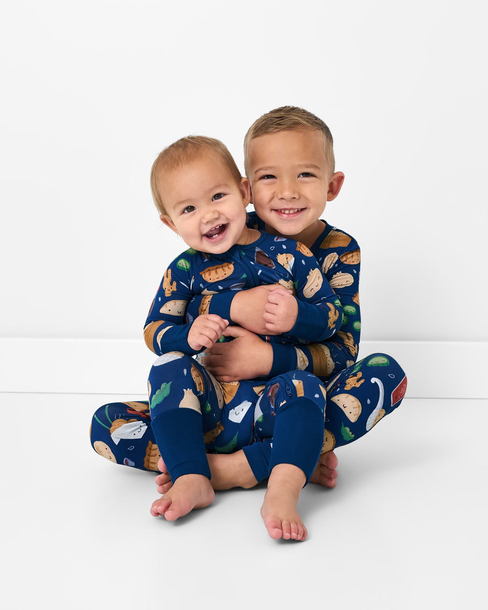 Two children wearing matching Bao Buddies bamboo kids pajamas