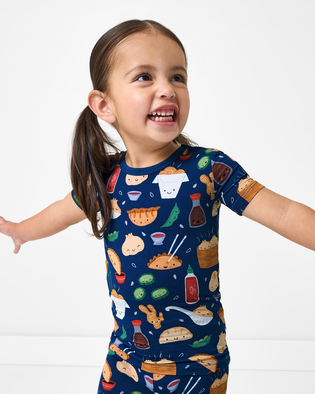 Close up of girl wearing the Bao Buddies Two-Piece Short Sleeve & Shorts Pajama Set