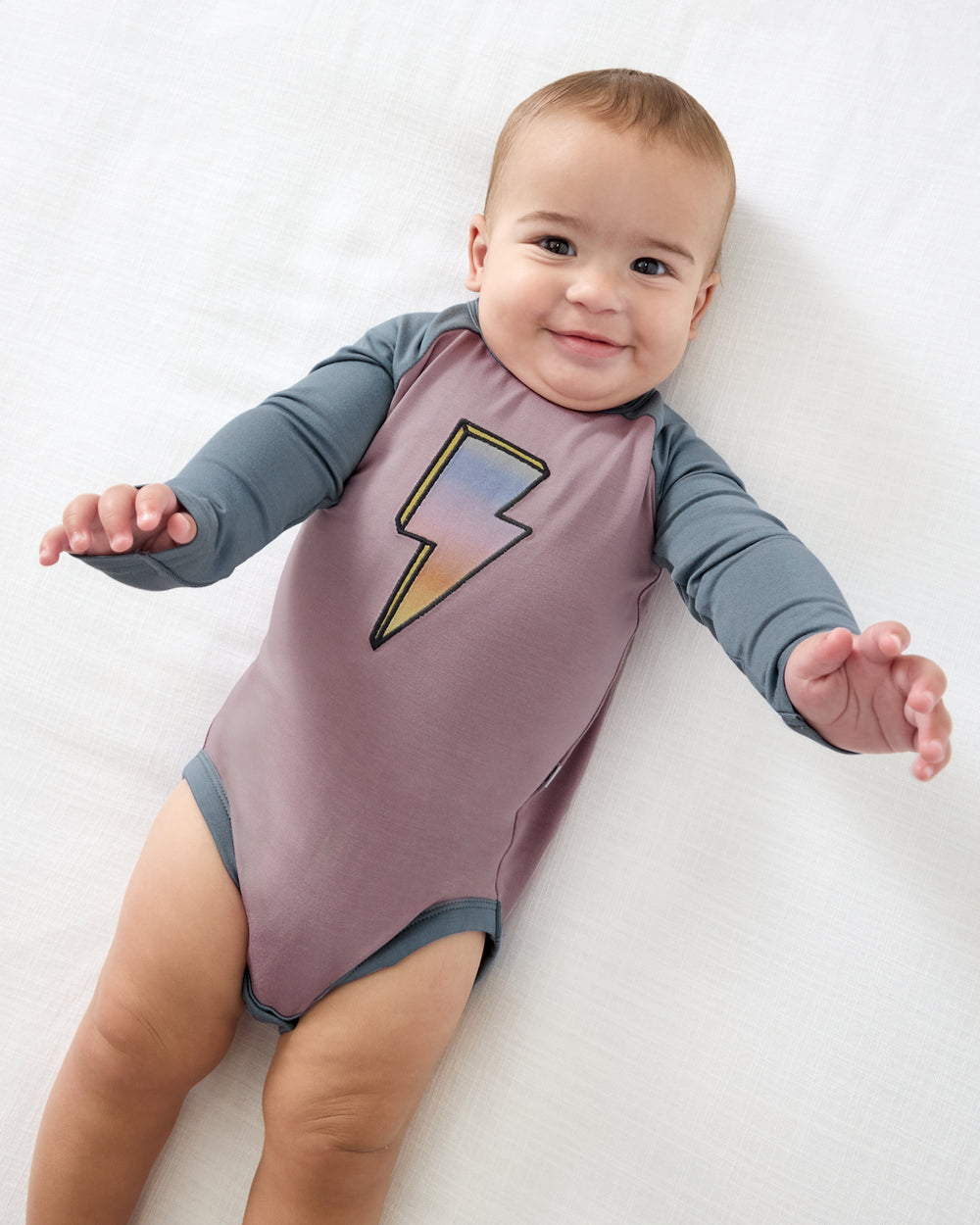 Aerial view of baby wearing the Bolt Raglan Bodysuit