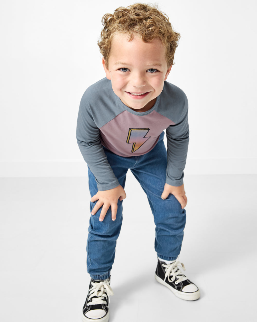 Child wearing the Bolt Raglan Teen with denim joggers
