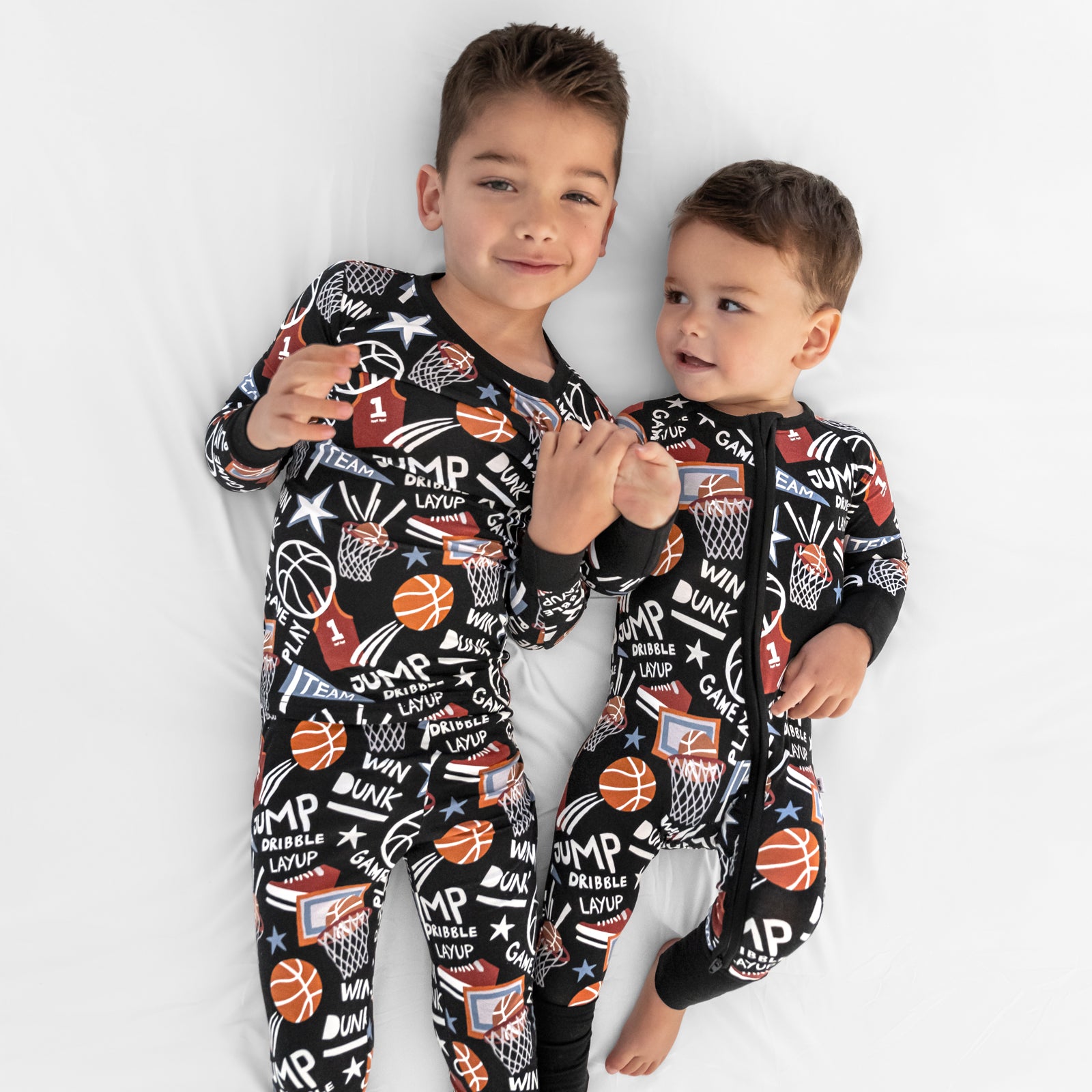 Ariel view of two children wearing matching Black Slam Dunk bamboo pajamas
