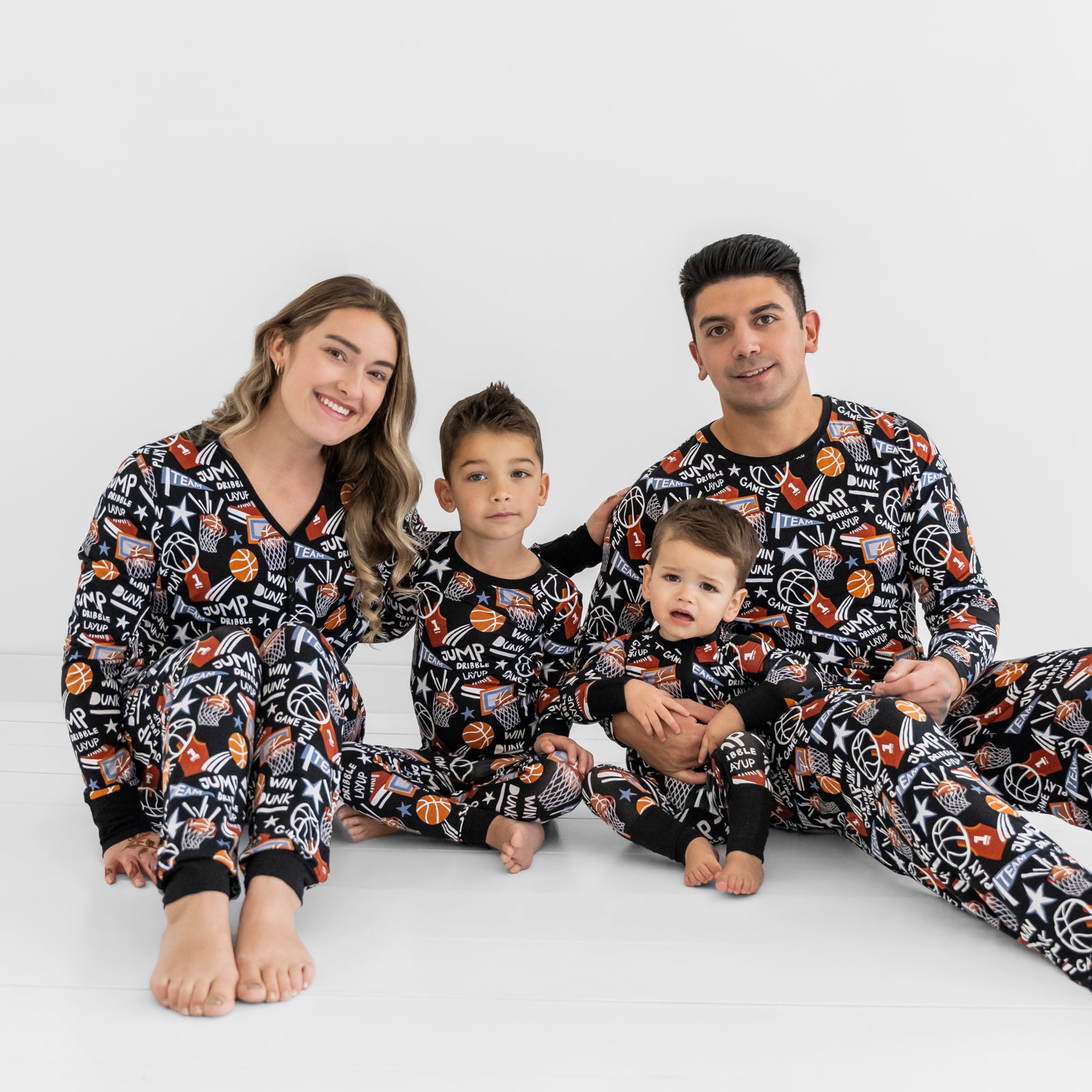Family of four wearing matching Black Slam Dunk bamboo pajamas