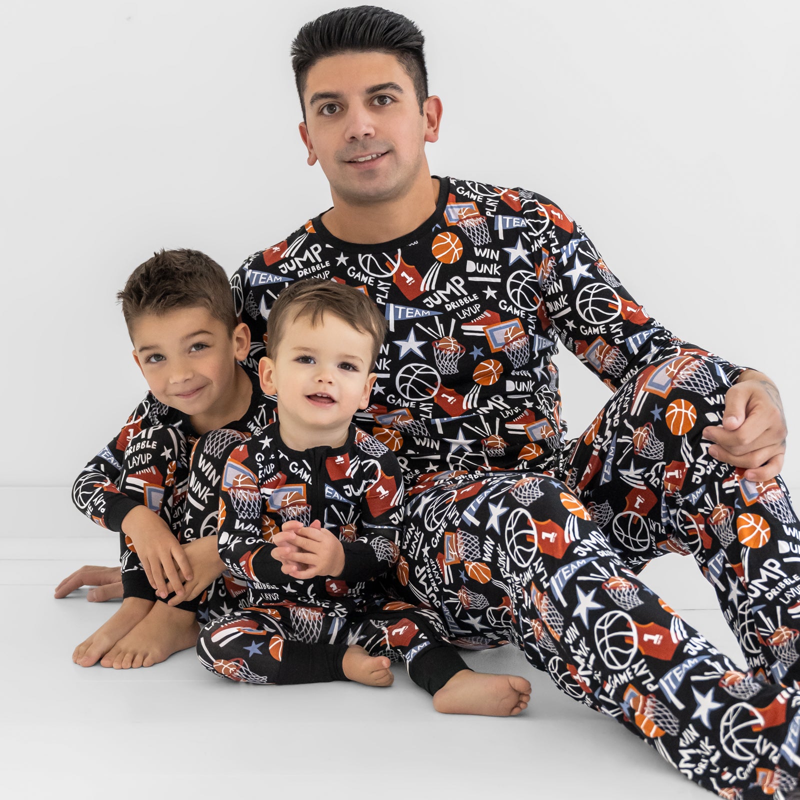 Father and two children wearing matching Black Slam Dunk bamboo pajamas