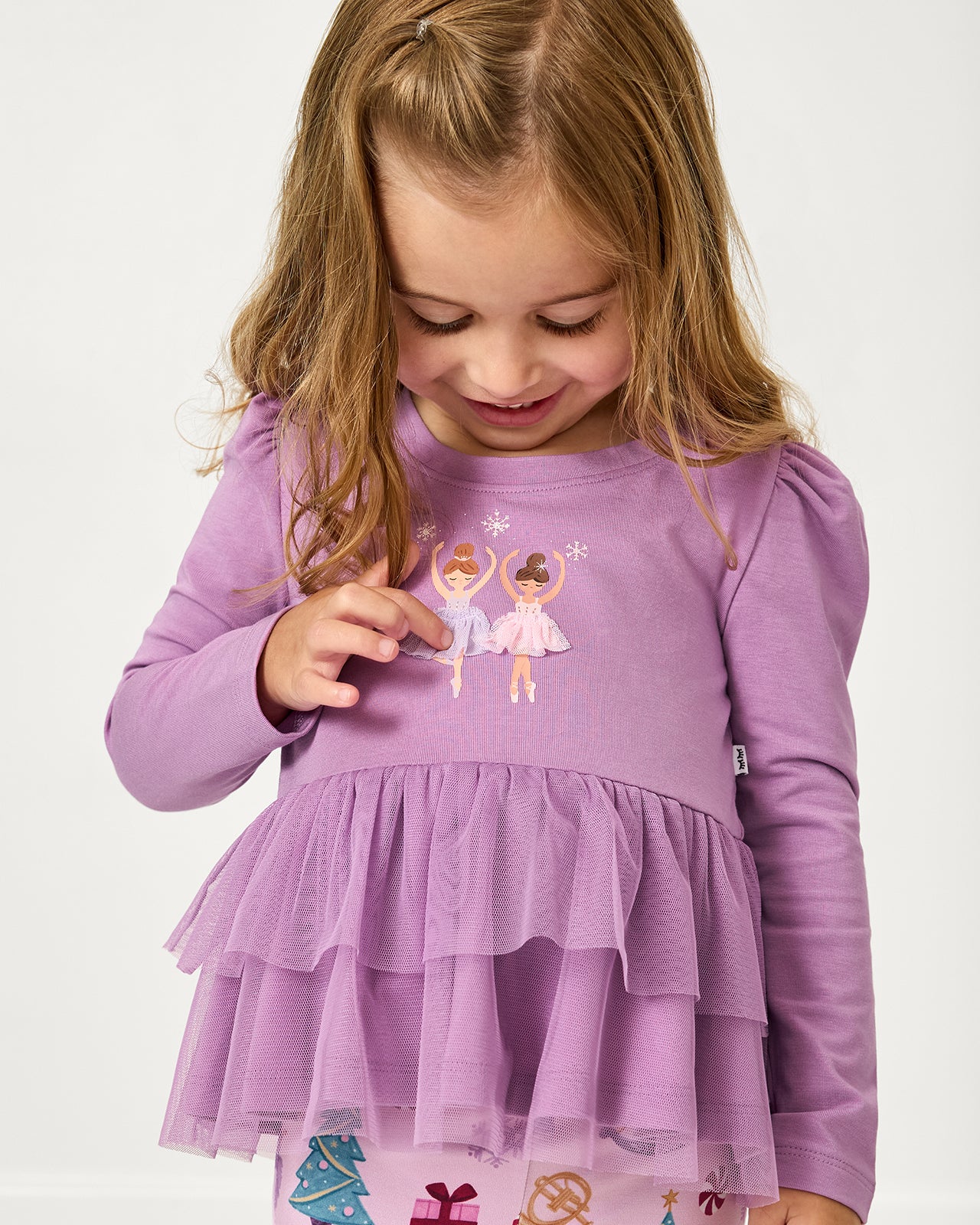 Girl touching the tulle detail on the Ballerina Tiered Peplum Top