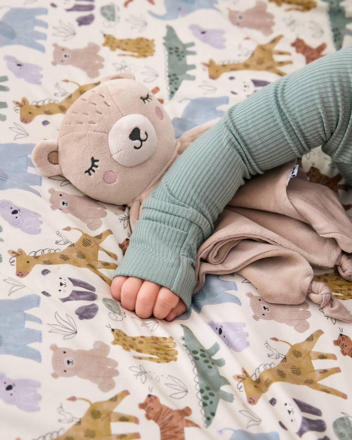 The Bear Sleepyhead Lovey on a safari themed blanket