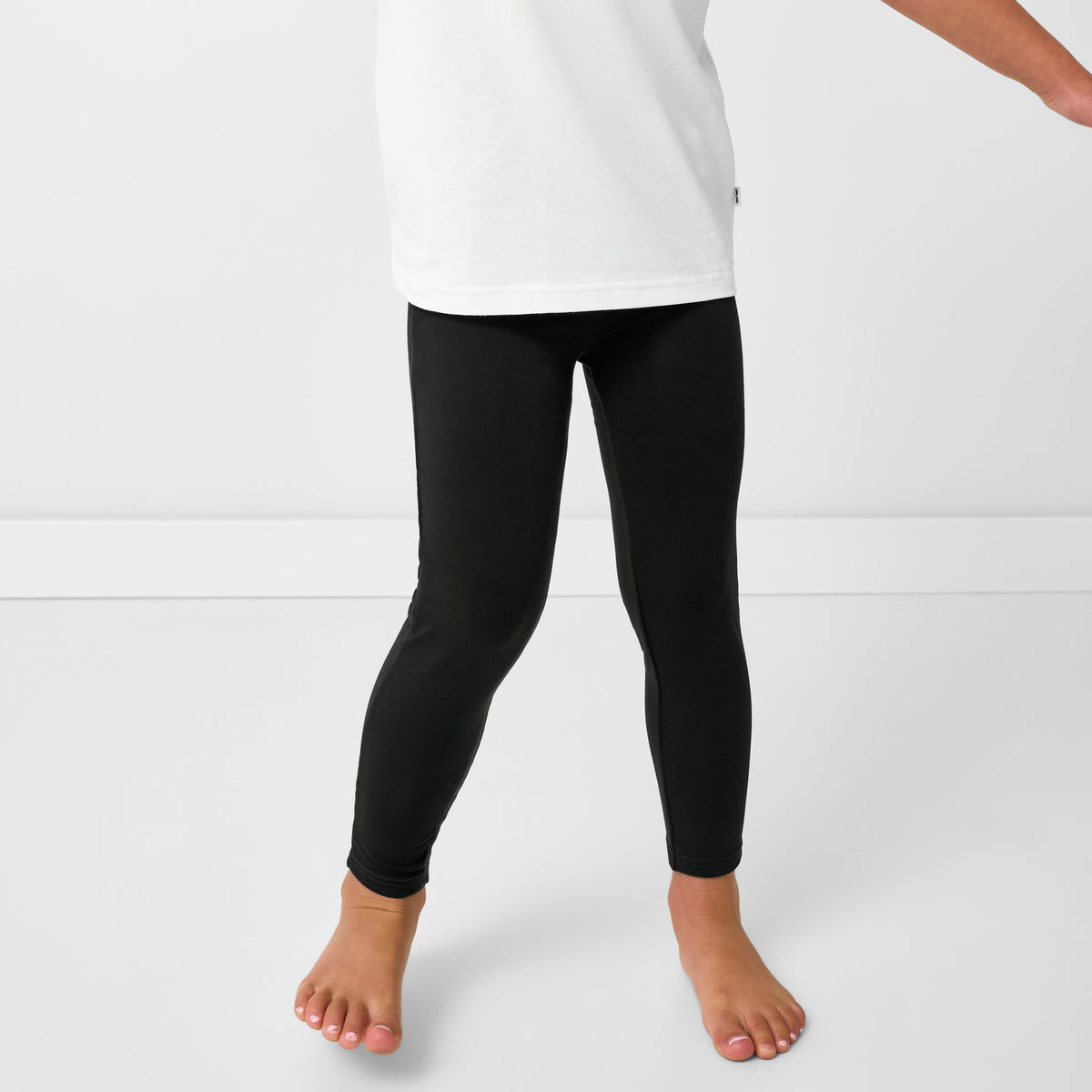 Close up of child wearing the Black Legging