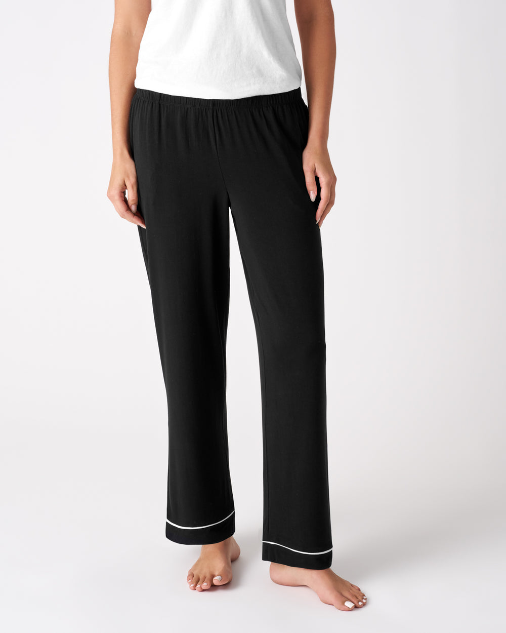 Woman wearing the Black Women's PJ Pants with a white top