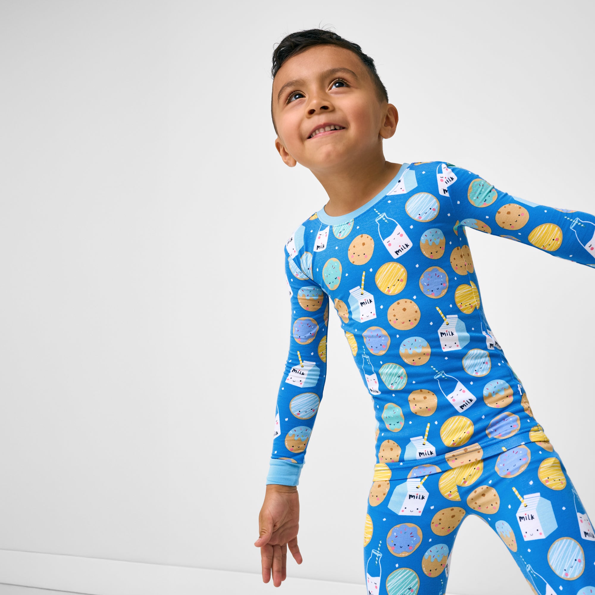 Close up of boy wearing the Blue Cookies & Milk Two-Piece Pajama Set