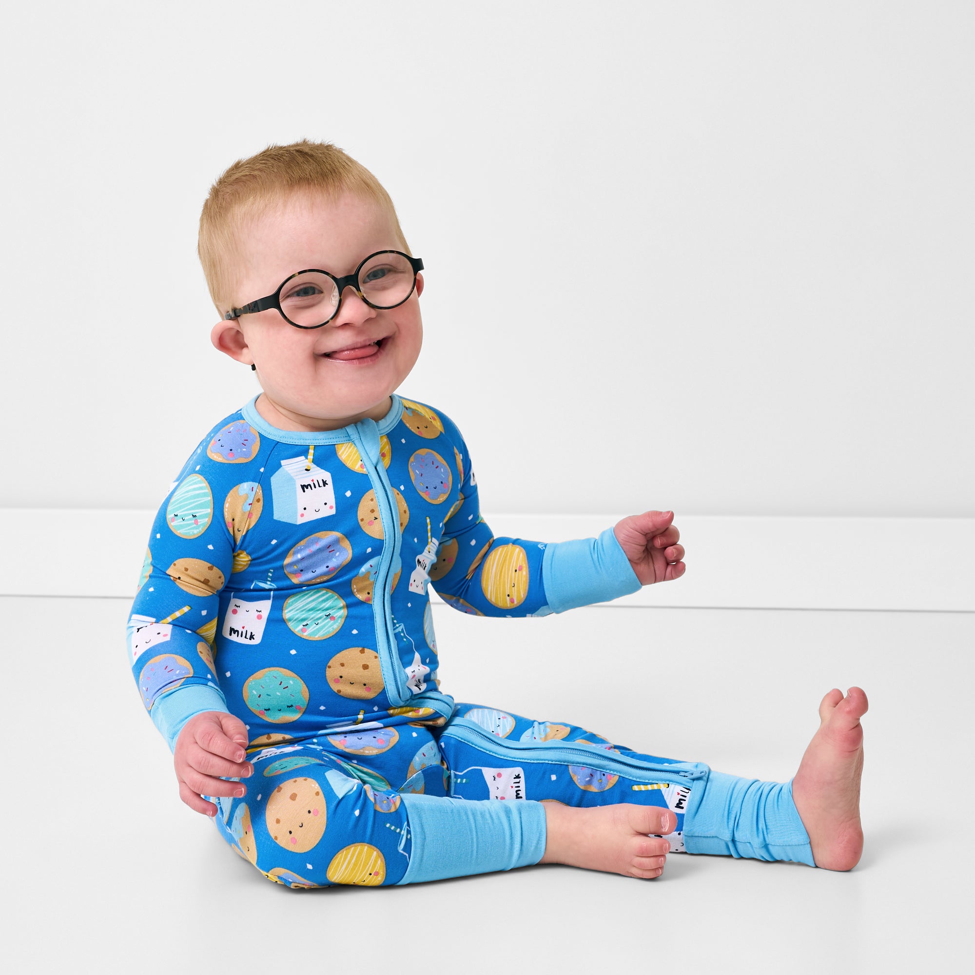 Sitting child wearing the Blue Cookies & Milk Zippy