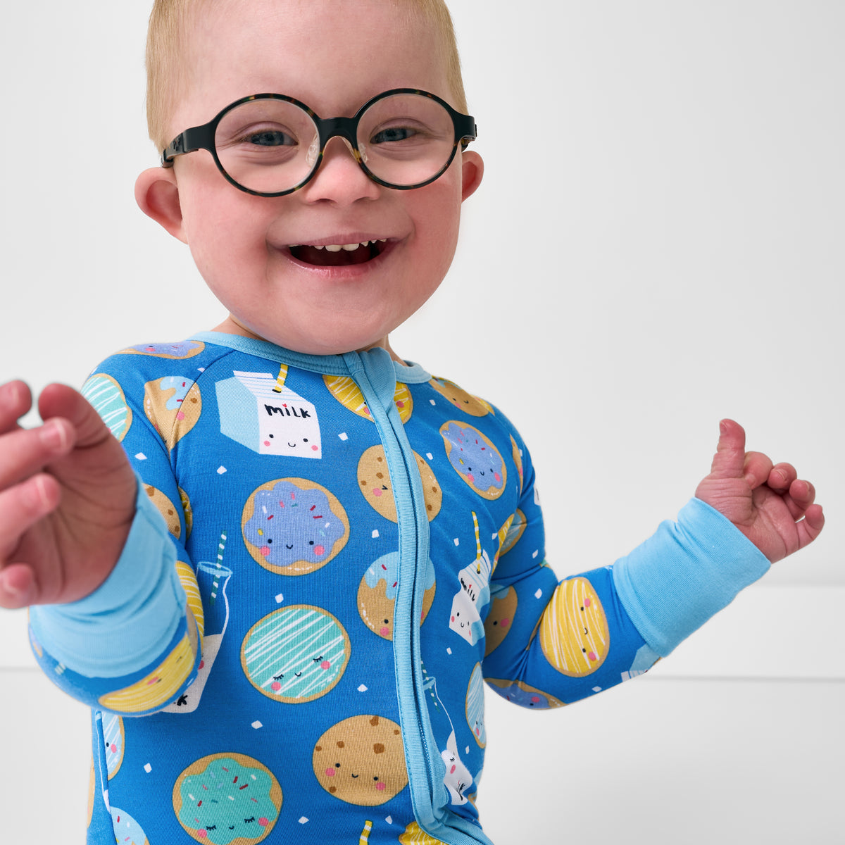 Close up of baby wearing the Blue Cookies & Milk Zippy