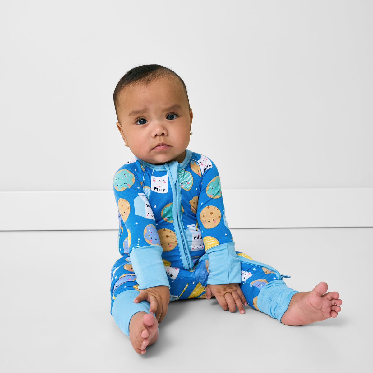 Sitting child wearing the Blue Cookies & Milk Zippy