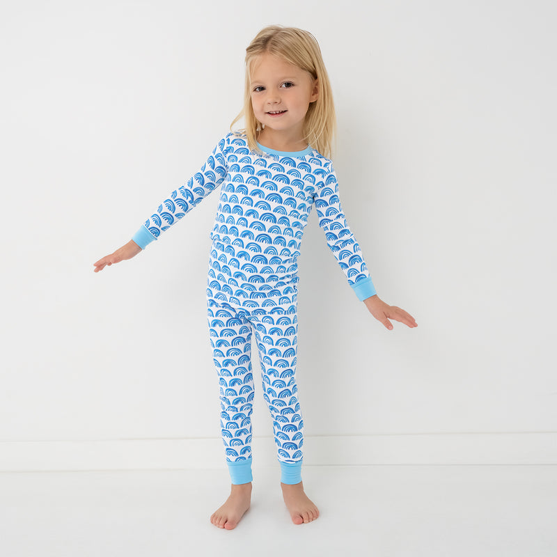 Standing child wearing the Blue Rainbows Two-Piece Pajama Set