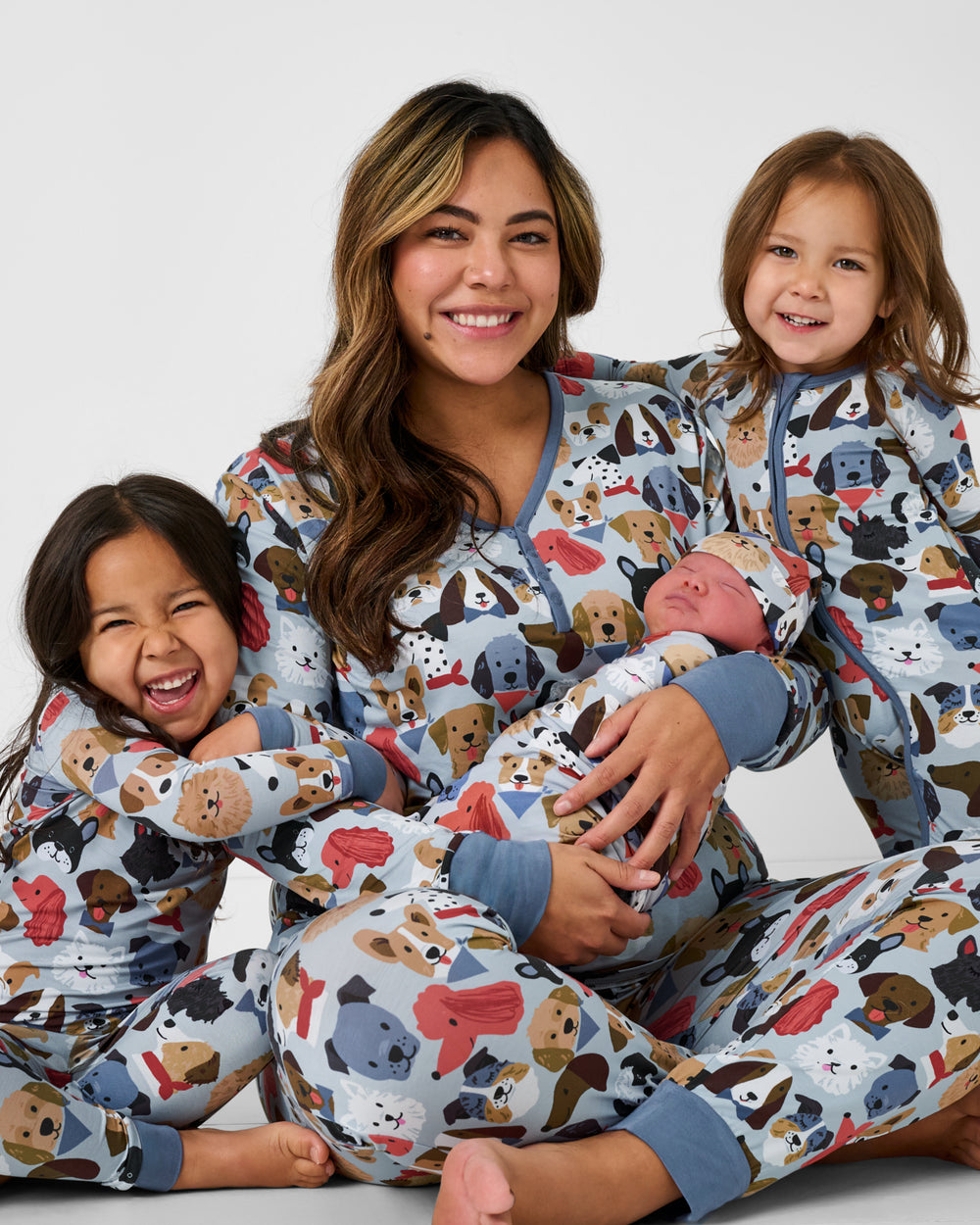 Woman and three children wearing matching Gray Puppy Parade bamboo pajamas