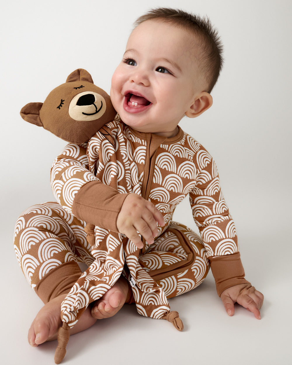 Baby hugging the Bowie the Bear Sleepyhead Lovey