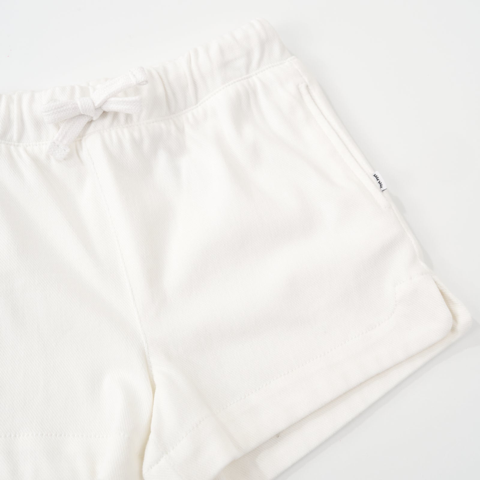 Macro view of the Bright White Denim Shorts