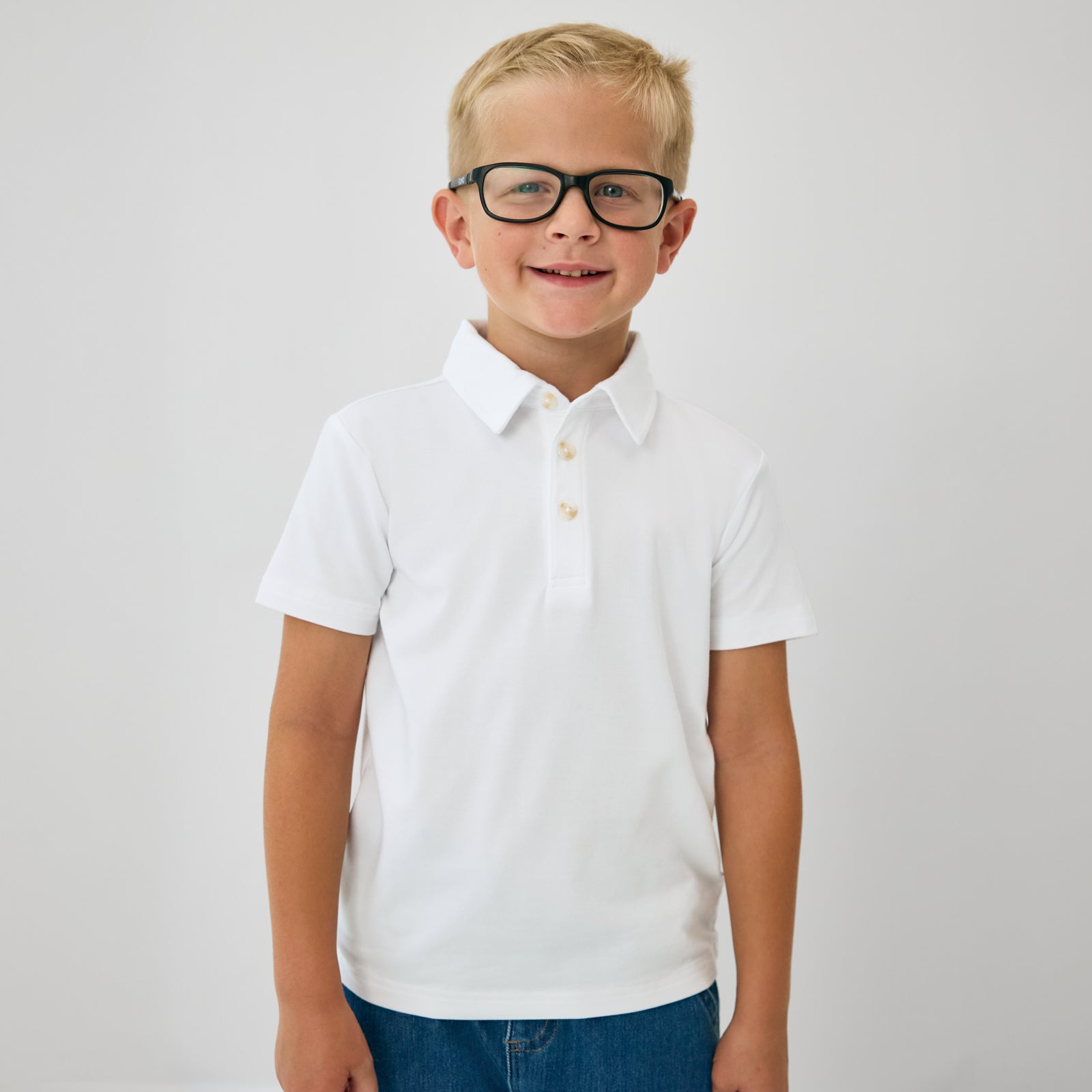 Close up of child wearing the Bright White Polo Shirt