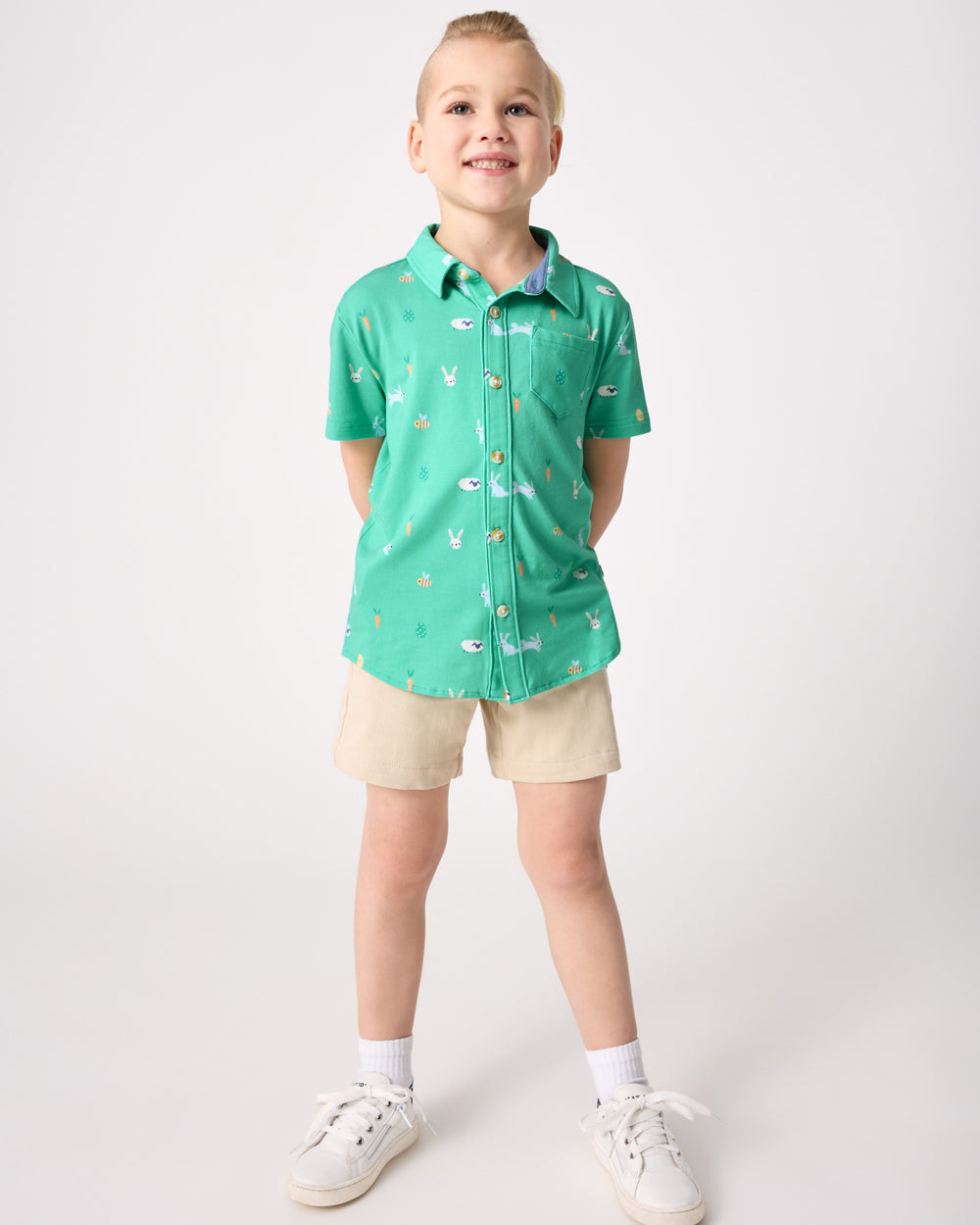 Boy wearing the Bunny Burrow Button Down Polo with khaki shorts