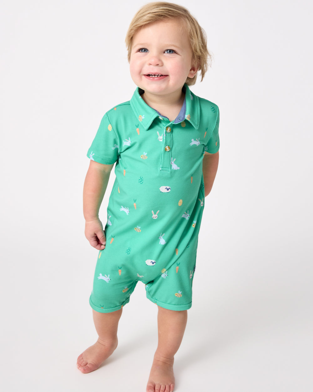 Walking toddler wearing the Bunny Burrow Polo Shorty Romper