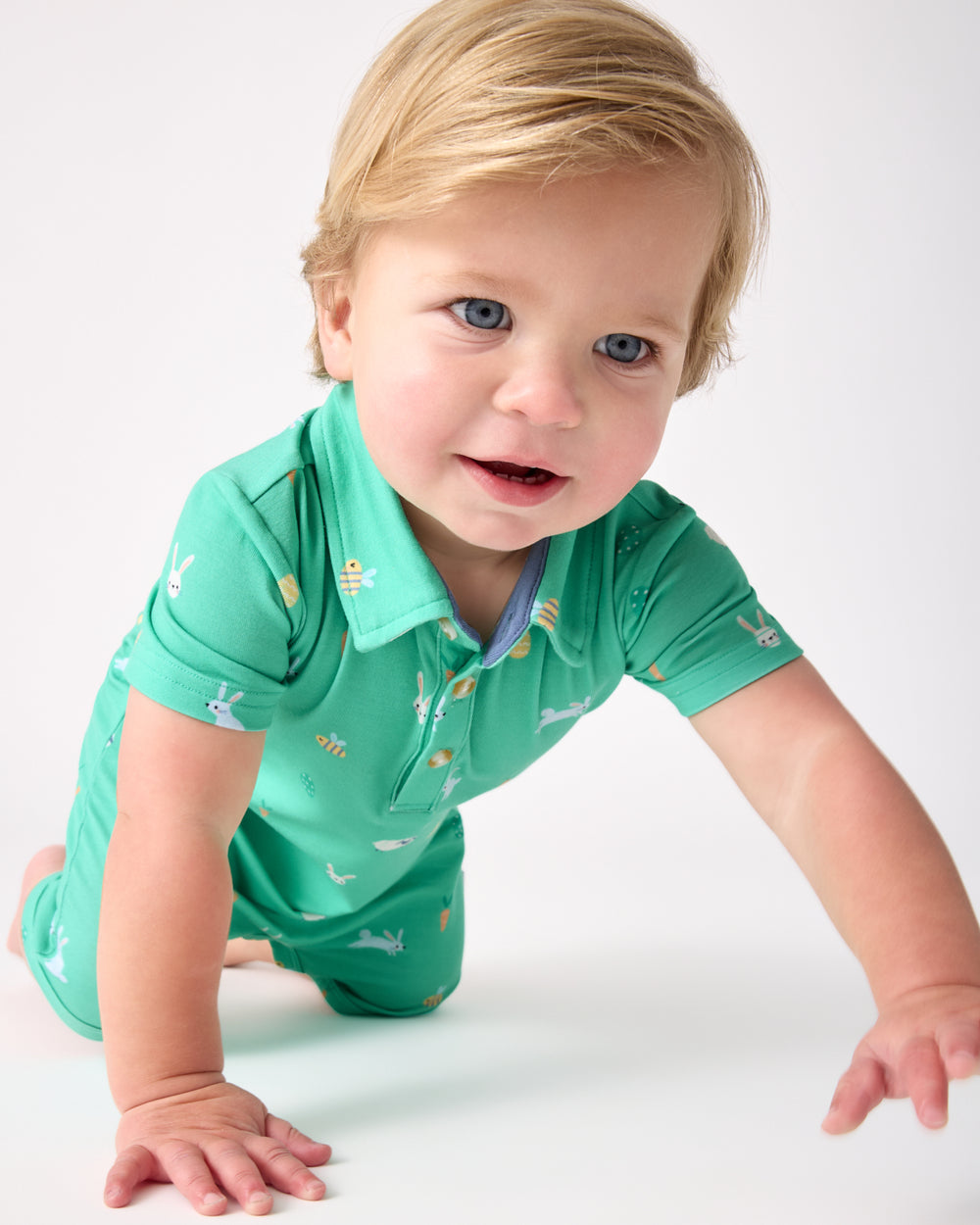 Crawling toddler wearing the Bunny Burrow Polo Shorty Romper