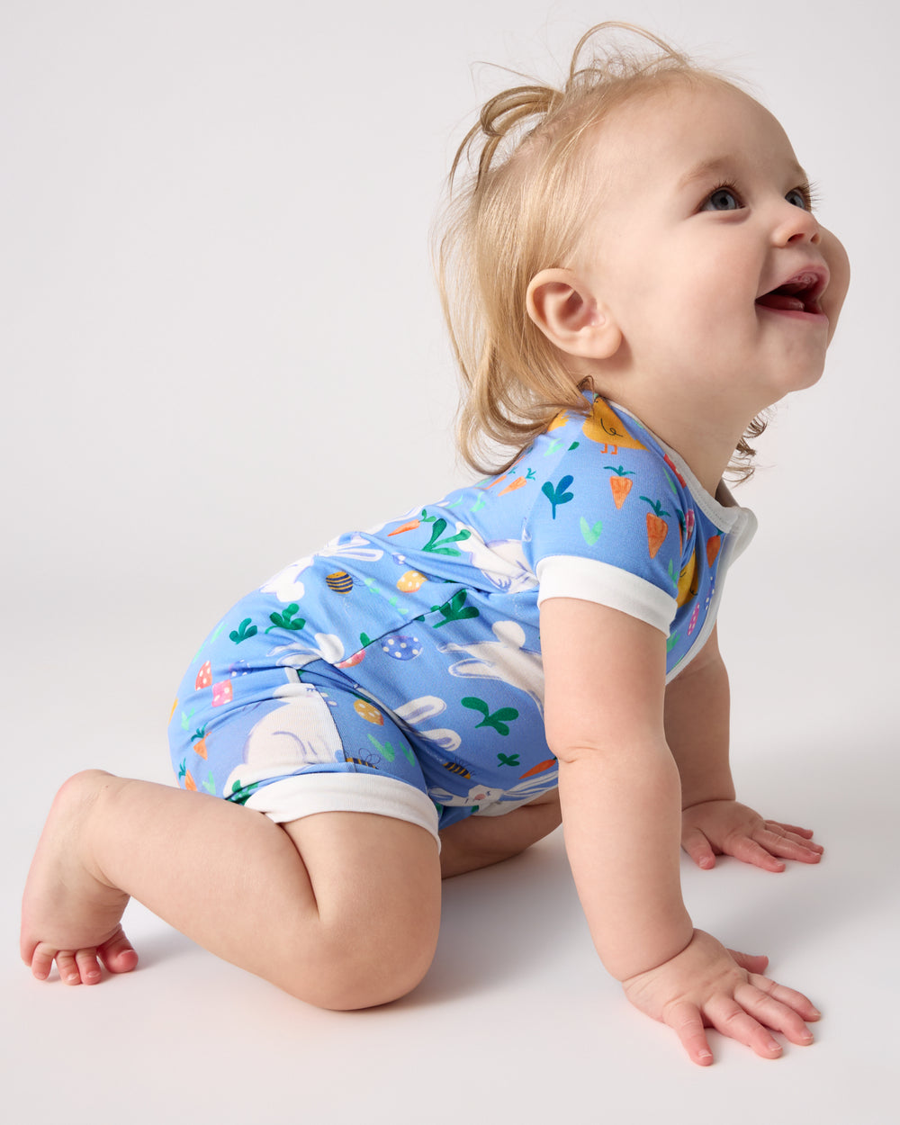 Crawling baby wearing the Bunny Patch Shorty Zippy