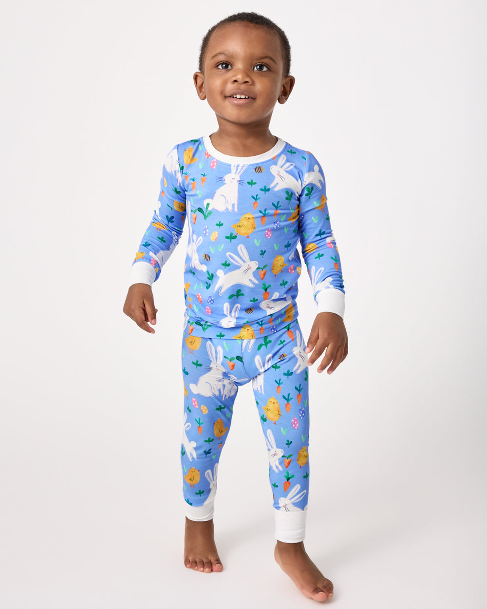 Standing boy wearing the Bunny Patch Two-Piece Pajama Set