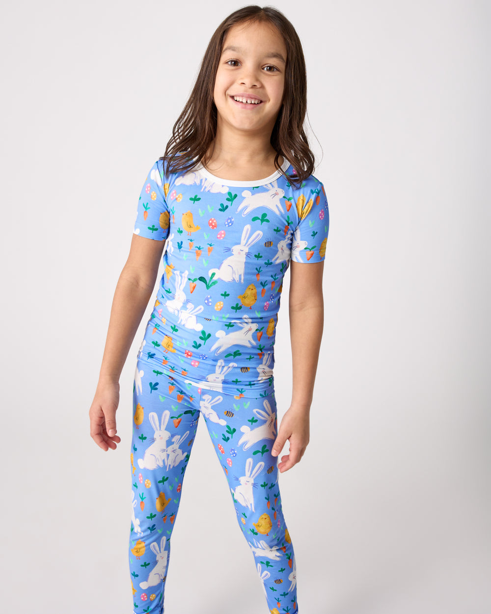 Standing girl wearing the Bunny Patch Two-Piece Short Sleeve Pajama Set