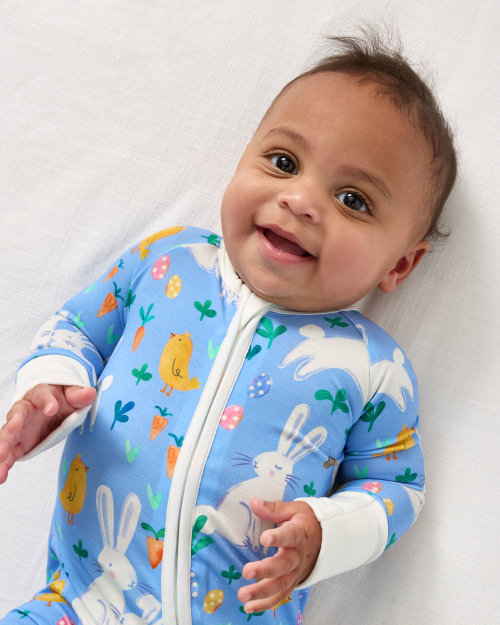 Close up of baby wearing the 
Bunny Patch Zippy
