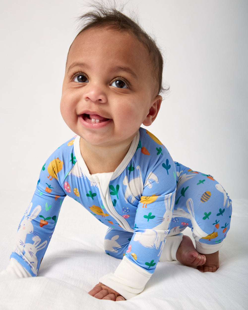 Crawling baby wearing the 
Bunny Patch Zippy